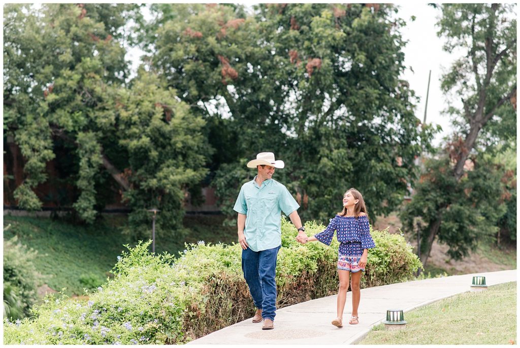 groom walking with daughter during engagement session