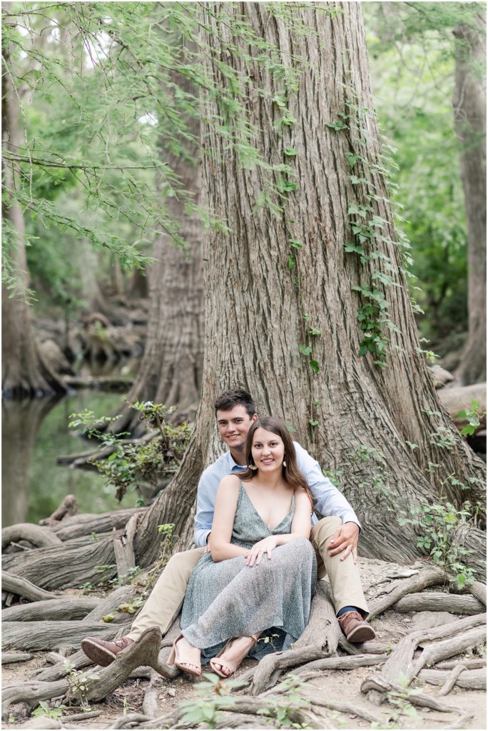 man and woman sitting on tree stump at cibolo nature center