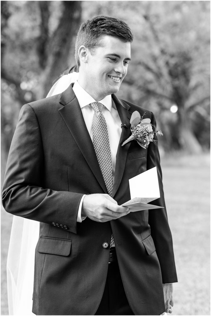 groom smiling at note from bride