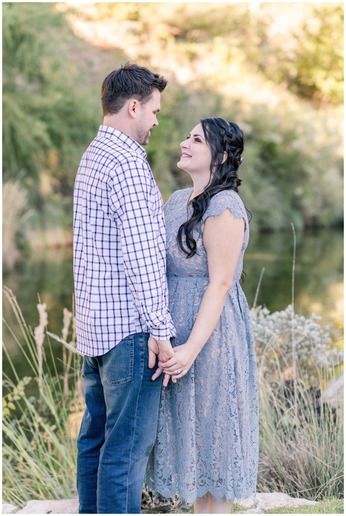 man and woman looking at each other for engagement photos