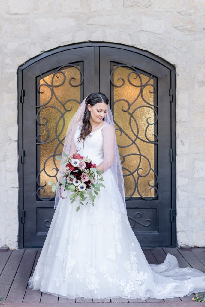 bride standing in front of door for bridal photos