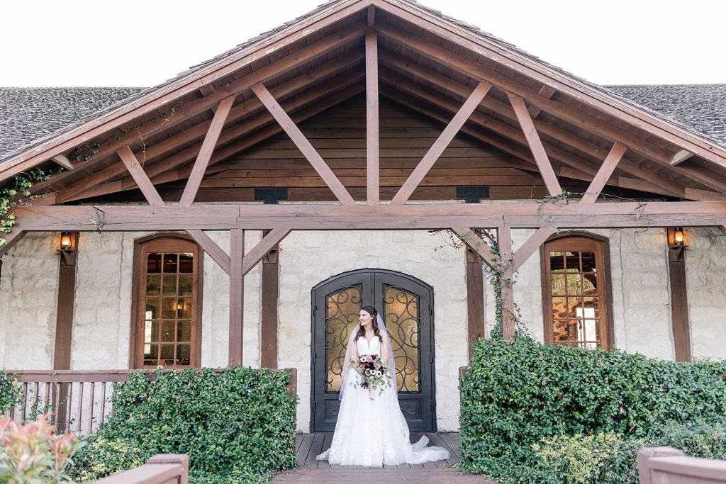 Bride standing at the doors of the milestone in new braunfels